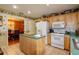 Functional kitchen with island, white appliances, and view into the dining area at 330 W Palmetto St, Lakeland, FL 33815