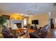 Spacious living room features a fireplace, ceiling fan, hardwood floors, and leather sofas at 330 W Palmetto St, Lakeland, FL 33815