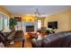 Cozy living room features a fireplace, wood flooring, and leather sofas under a fan at 330 W Palmetto St, Lakeland, FL 33815