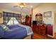 A spacious bedroom with a four poster bed, ceiling fan and wood flooring at 330 W Palmetto St, Lakeland, FL 33815
