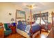 A spacious bedroom with a four poster bed, ceiling fan and wood flooring at 330 W Palmetto St, Lakeland, FL 33815