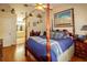 A spacious bedroom with a four poster bed, ceiling fan and wood flooring at 330 W Palmetto St, Lakeland, FL 33815