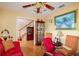 View of the office from a doorway, featuring a red sofa, chairs, desk and staircase at 330 W Palmetto St, Lakeland, FL 33815