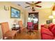 Home office with a red couch, two chairs, a ceiling fan, and built-in shelving at 330 W Palmetto St, Lakeland, FL 33815