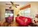 Cozy office with a built-in desk, red sofa, and a ceiling fan at 330 W Palmetto St, Lakeland, FL 33815