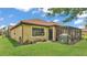 Charming backyard featuring a screened lanai, well-kept lawn, and beautiful landscaping around the home's perimeter at 3926 Aquilla Dr, Lakeland, FL 33810