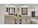 Bright bathroom featuring double granite sinks and framed mirrors, with tile flooring at 3926 Aquilla Dr, Lakeland, FL 33810