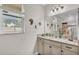 Bright bathroom featuring a granite-topped vanity, nautical decor, and a window with a view at 3926 Aquilla Dr, Lakeland, FL 33810