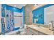 Bright blue bathroom featuring a shower/tub combo, textured wall, and granite vanity top at 3926 Aquilla Dr, Lakeland, FL 33810