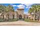 Elegant clubhouse exterior featuring stone accents, arched entryways, and lush landscaping, creating a welcoming atmosphere at 3926 Aquilla Dr, Lakeland, FL 33810