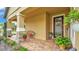 Charming front porch with stone pillars, paver flooring, and a decorative front door at 3926 Aquilla Dr, Lakeland, FL 33810