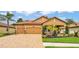 Inviting home featuring manicured landscaping, a paver driveway, and a warm, neutral color palette at 3926 Aquilla Dr, Lakeland, FL 33810