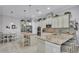 A gourmet kitchen boasts stainless appliances, an island with seating, and ample cabinet space at 3926 Aquilla Dr, Lakeland, FL 33810