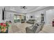 Bright living room with access to the patio, comfortable seating, and a ceiling fan at 3926 Aquilla Dr, Lakeland, FL 33810