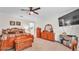 Carpeted main bedroom with a ceiling fan, wooden furniture, and a television at 3926 Aquilla Dr, Lakeland, FL 33810