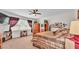 Carpeted main bedroom with a ceiling fan, wooden furniture and a window at 3926 Aquilla Dr, Lakeland, FL 33810