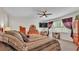 Spacious main bedroom features wood furniture, a ceiling fan, and a large television for relaxing entertainment at 3926 Aquilla Dr, Lakeland, FL 33810
