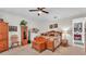 Carpeted main bedroom with a ceiling fan, wooden furniture, and views into the hallway at 3926 Aquilla Dr, Lakeland, FL 33810