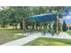 Shaded picnic area with tables on a grassy lawn, perfect for outdoor gatherings and relaxation at 3926 Aquilla Dr, Lakeland, FL 33810