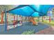 Community playground featuring slides, climbing structures, and a shade cover for sunny days at 3926 Aquilla Dr, Lakeland, FL 33810