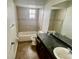 Bathroom with a shower-tub combo, vanity, and toilet at 4038 Lehman Ln, Lakeland, FL 33813