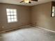 Neutral bedroom with a ceiling fan and a bright window, ready to be styled at 4038 Lehman Ln, Lakeland, FL 33813