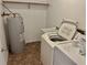 Functional laundry area with a utility sink, washer, dryer, and water heater at 4038 Lehman Ln, Lakeland, FL 33813
