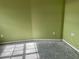 Room with green walls, a window letting in natural light, and electrical outlets at 4038 Lehman Ln, Lakeland, FL 33813