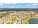 An aerial view of a well-maintained residential area, showcasing numerous houses with terracotta roofs at 4088 Prima Lago Cir, Lakeland, FL 33810