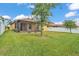 Backyard with a screened-in patio and white fence at 4088 Prima Lago Cir, Lakeland, FL 33810
