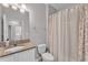 Bathroom featuring granite countertops, a shower with a curtain, and access to the laundry room at 4088 Prima Lago Cir, Lakeland, FL 33810