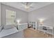 Bright bedroom with a window, desk, dresser, ceiling fan, and a bookcase at 4088 Prima Lago Cir, Lakeland, FL 33810