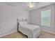 Cozy bedroom with carpet, ceiling fan, and a window letting in natural light at 4088 Prima Lago Cir, Lakeland, FL 33810