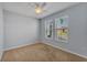 Bright bedroom with neutral carpet, a ceiling fan, and two windows offering natural light at 4088 Prima Lago Cir, Lakeland, FL 33810
