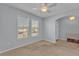 Cozy bedroom featuring neutral carpeting, a ceiling fan, and two bright windows at 4088 Prima Lago Cir, Lakeland, FL 33810