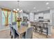 Open dining area flowing into a well-equipped kitchen with a view of the living area at 4088 Prima Lago Cir, Lakeland, FL 33810