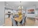 Open concept dining room with chandelier, view of kitchen and decorative stone accent wall at 4088 Prima Lago Cir, Lakeland, FL 33810