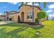 Attractive house featuring a well-kept lawn, decorative landscaping, and a brick-paved driveway at 4088 Prima Lago Cir, Lakeland, FL 33810