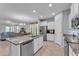 Modern kitchen with granite countertops, a stainless steel refrigerator, and views into the living area at 4088 Prima Lago Cir, Lakeland, FL 33810