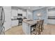 Well-appointed kitchen featuring white cabinetry, granite counters, a tiled backsplash, and an island with seating at 4088 Prima Lago Cir, Lakeland, FL 33810