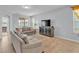 Bright living room featuring neutral paint, tile floors, comfortable sofas, and stylish furnishings at 4088 Prima Lago Cir, Lakeland, FL 33810