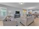 Spacious living room showcasing tile floors, comfortable seating, and an open layout to the dining area at 4088 Prima Lago Cir, Lakeland, FL 33810