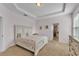 Airy primary bedroom features tray ceilings, neutral colors, carpet flooring, and ensuite access at 4088 Prima Lago Cir, Lakeland, FL 33810