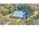 Aerial view of full sport court with basketball and multiple other games surrounded by lush trees at 4088 Prima Lago Cir, Lakeland, FL 33810