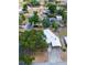 Aerial view of a residential property with mature trees, a driveway, and surrounding homes at 415 Manor Dr, Bartow, FL 33830