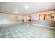 The spacious basement features mixed flooring, an open layout and entry to the kitchen area at 415 Manor Dr, Bartow, FL 33830