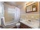 Bright bathroom features yellow tile, white shower curtain, and sink with cabinet at 415 Manor Dr, Bartow, FL 33830