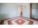 Bedroom with patterned tile floors, light blue walls, and a closet with curtains at 415 Manor Dr, Bartow, FL 33830