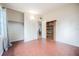 Bedroom with tile floors, closet, shelving, and a large window with curtains at 415 Manor Dr, Bartow, FL 33830