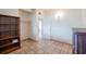 Neutral bedroom features tile floor, a closet, shelving, and a large woven dresser at 415 Manor Dr, Bartow, FL 33830